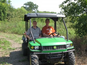 Volunteers driving 4WD John Deere Gator